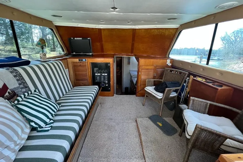 Slide: The Image of Interior of 1963 Hatteras 34 Convertible yacht with striped seating and wooden accents. - 28