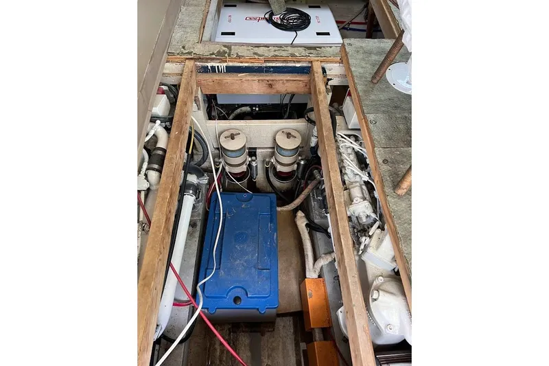 Slide: The Image of Engine compartment of a 1963 Hatteras 34 Convertible boat, showcasing mechanical components. - 35