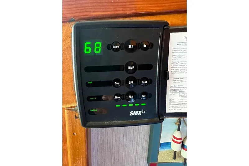 Slide: The Image of SMXir control panel on 1963 Hatteras 34 Convertible boat, displaying temperature settings. - 38