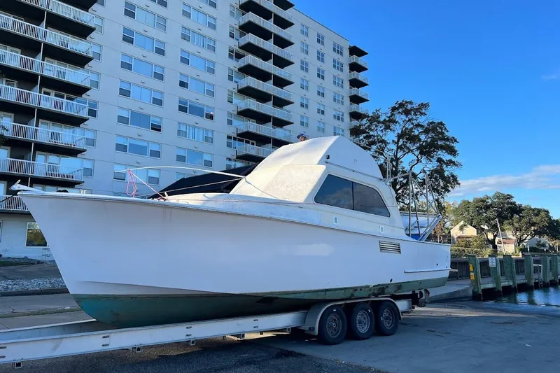 Slide: The Image of 1963 Hatteras 36 Sport Fisherman boat on trailer near waterfront building. - 41