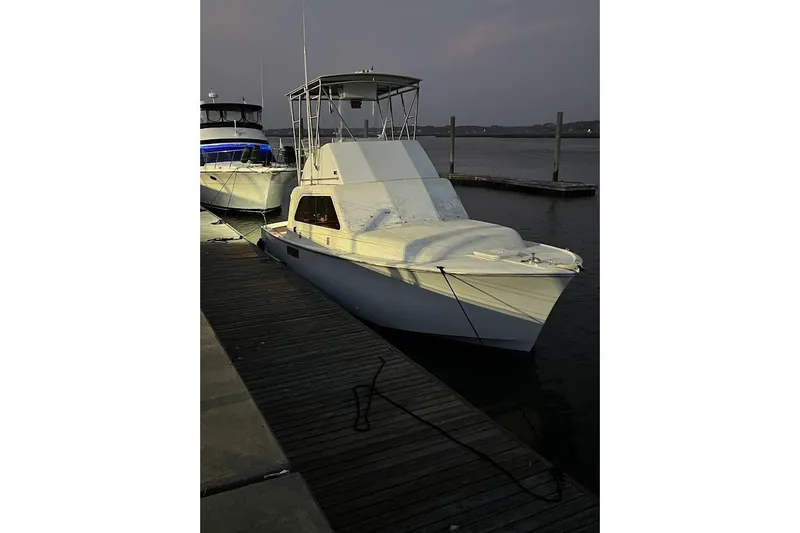 Slide: The Image of 1963 Hatteras 34 Convertible yacht docked at sunset. - 15