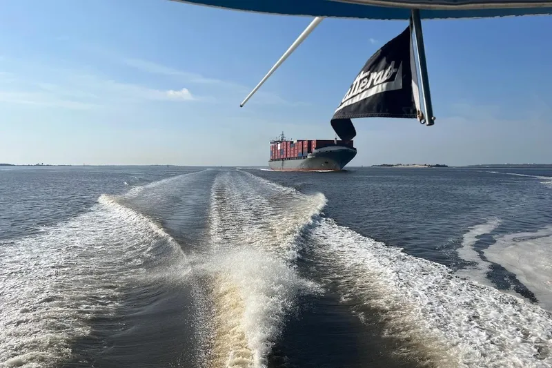 Slide: The Image of Wake of 1963 Hatteras 34 Convertible with cargo ship in the distance. - 16