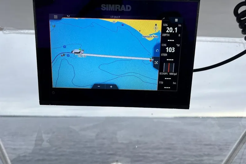 Slide: The Image of Simrad navigation display on 1963 Hatteras 34 Convertible boat, showing marine map and data. - 19