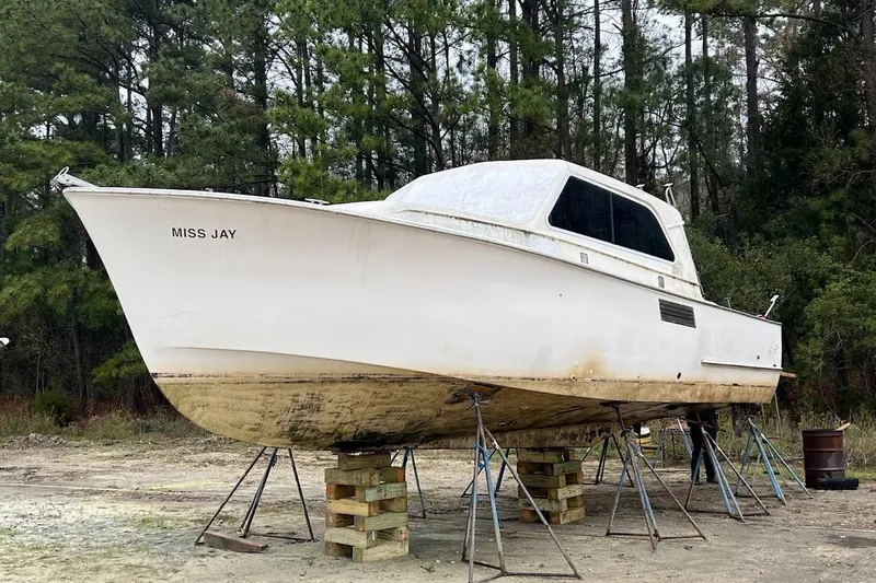 Slide: The Image of 1963 Hatteras 34 Convertible boat "Miss Jay" on stands in wooded area. - 5