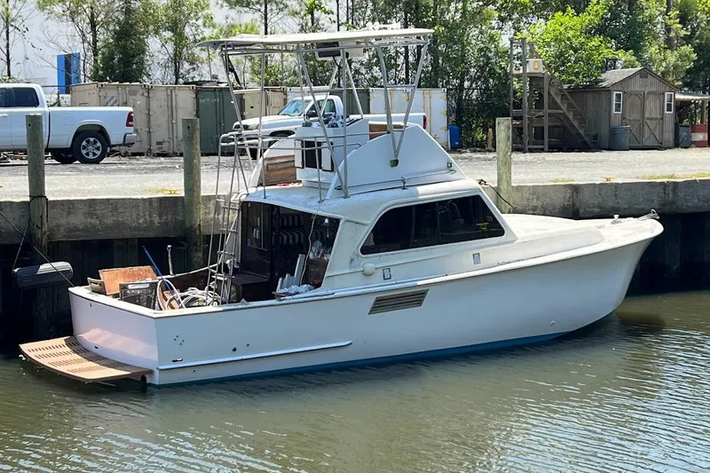 Slide: The Image of 1963 Hatteras 34 Convertible boat docked at marina, side view. - 8