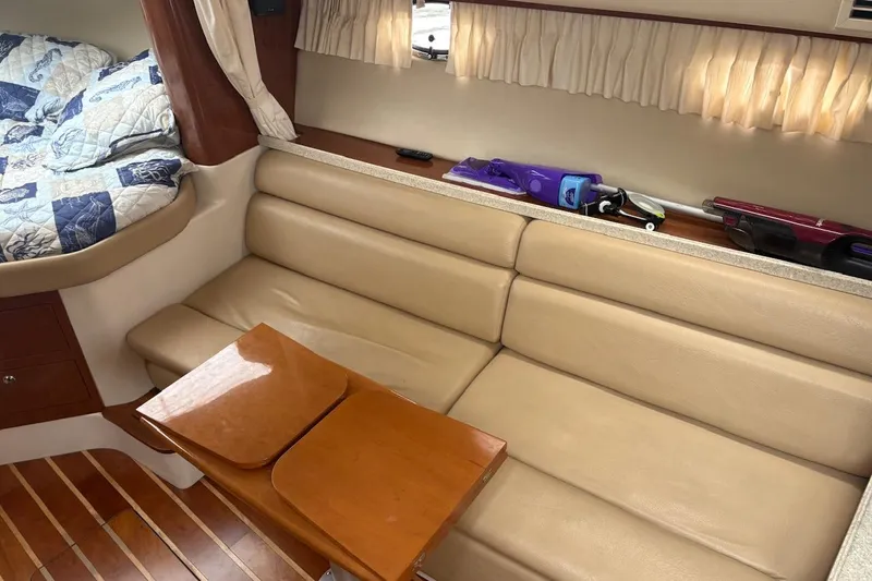 Slide: The Image of Interior of 2010 Regal 3360 Window Express with beige seating and wooden table. - 12