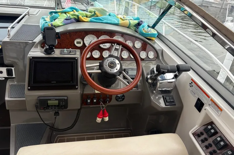 Slide: The Image of Cockpit of 2010 Regal 3360 Window Express boat with steering wheel and control panel. - 14