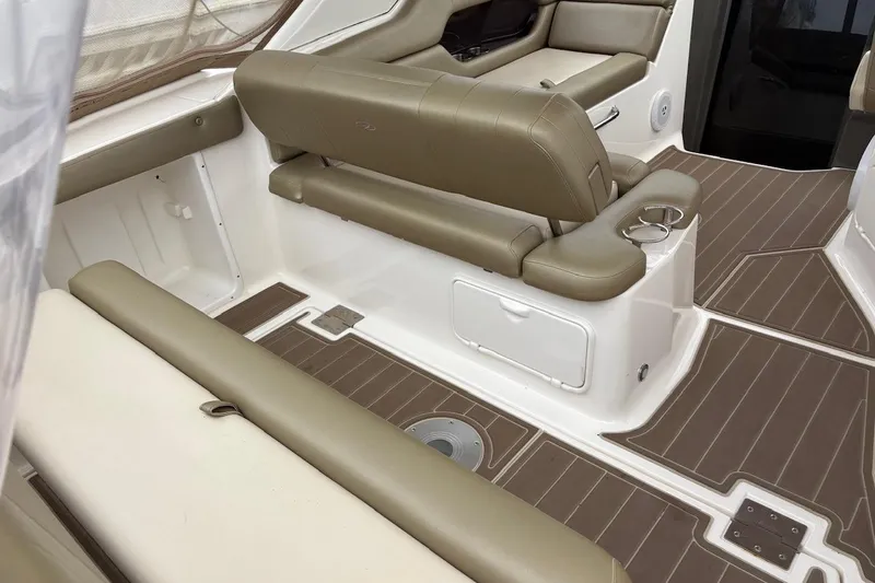 Slide: The Image of 2010 Regal 3360 Window Express interior with beige seating and wood-patterned flooring. - 16