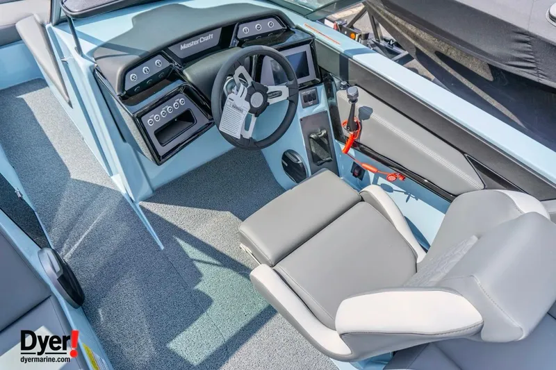 Slide: The Image of 2026 MasterCraft NXT24 boat interior with modern dashboard and steering wheel. - 10