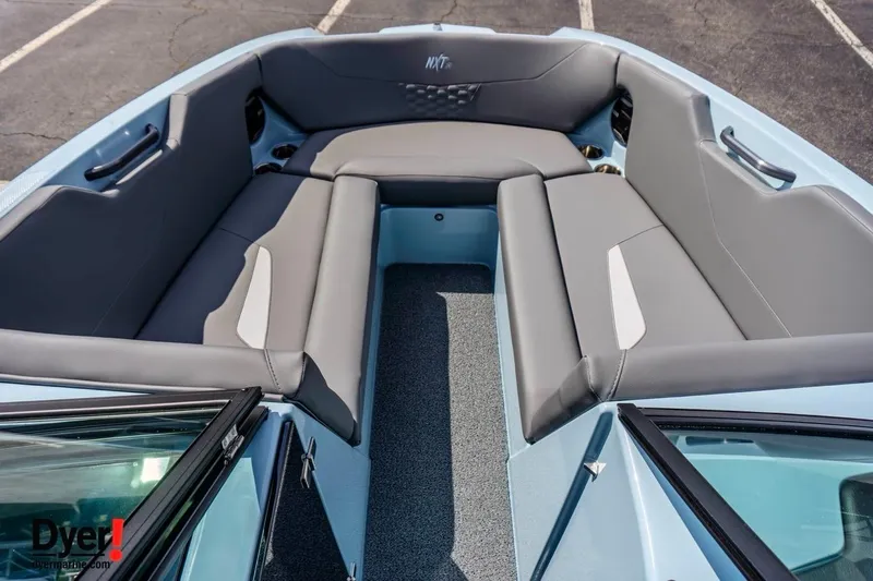 Slide: The Image of 2026 MasterCraft NXT24 boat interior with gray seating and spacious layout. - 11