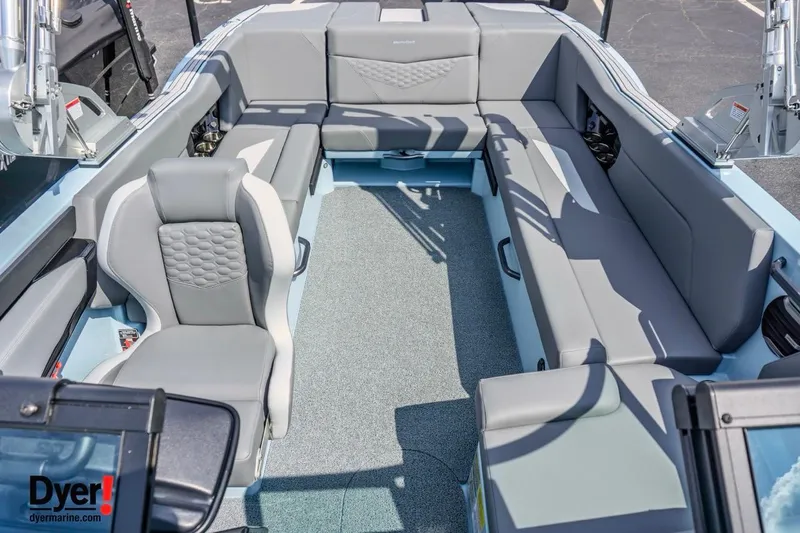 Slide: The Image of 2026 MasterCraft NXT24 boat interior with gray seating and carpeted floor. - 12