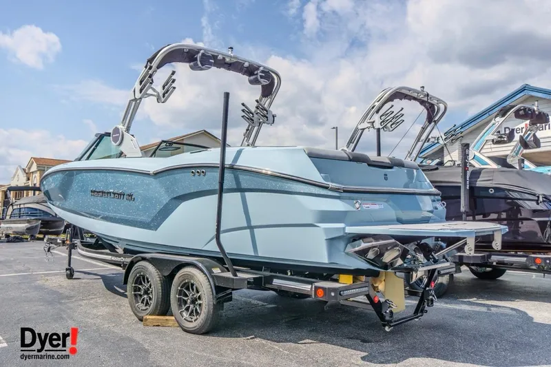 Slide: The Image of 2026 MasterCraft NXT24 boat on trailer at Dyer Marine dealership. - 2
