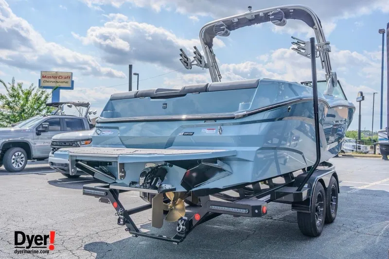 Slide: The Image of 2026 MasterCraft NXT24 boat on trailer in sunny dealership lot. - 3