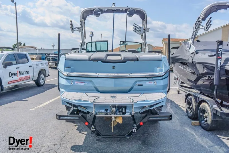 Slide: The Image of 2026 MasterCraft NXT24 boat displayed at Dyer Marine dealership. - 4