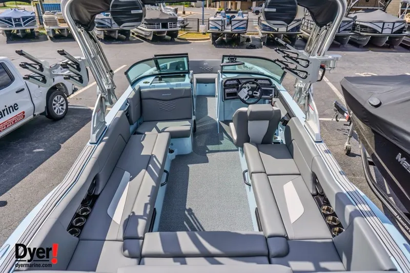 Slide: The Image of 2026 MasterCraft NXT24 boat interior with spacious seating and modern dashboard. - 7