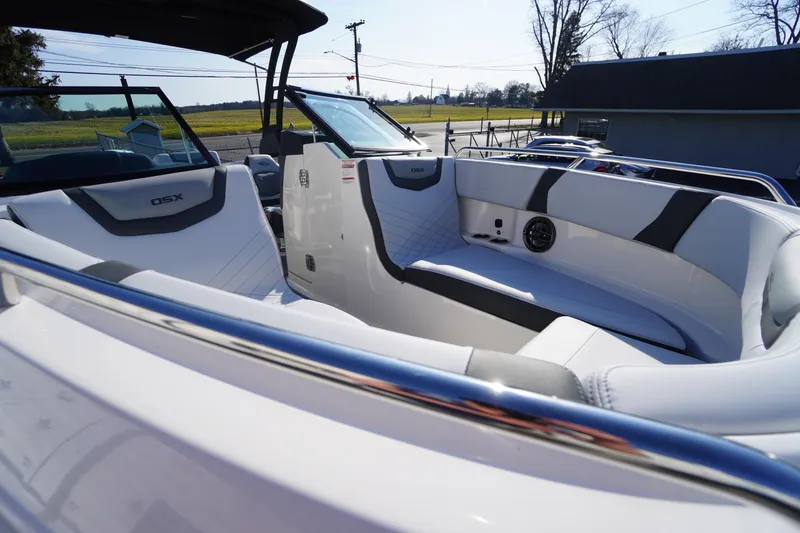 Slide: The Image of 2026 Chaparral 250 OSX boat interior with sleek seating and modern design. - 14