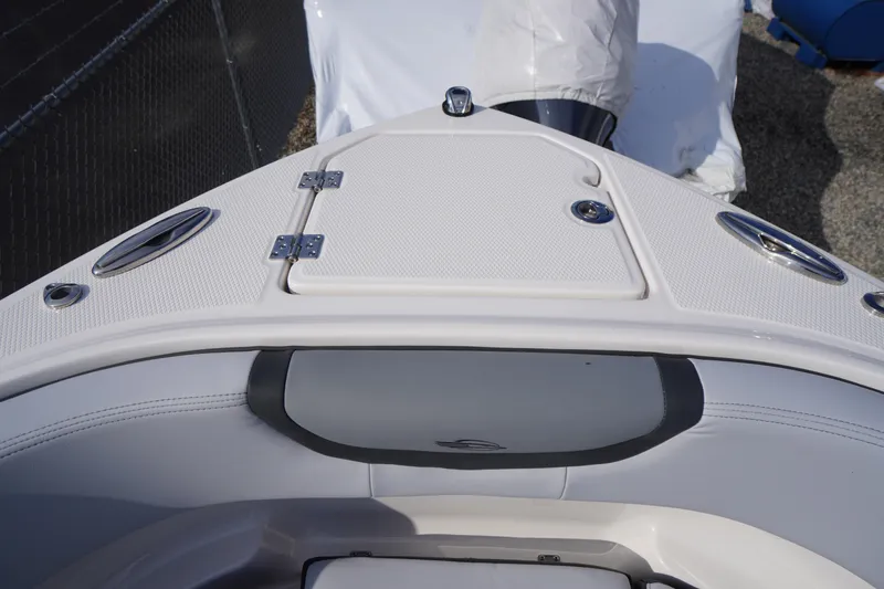 Slide: The Image of 2026 Chaparral 250 OSX boat bow with seating and storage compartment. - 4