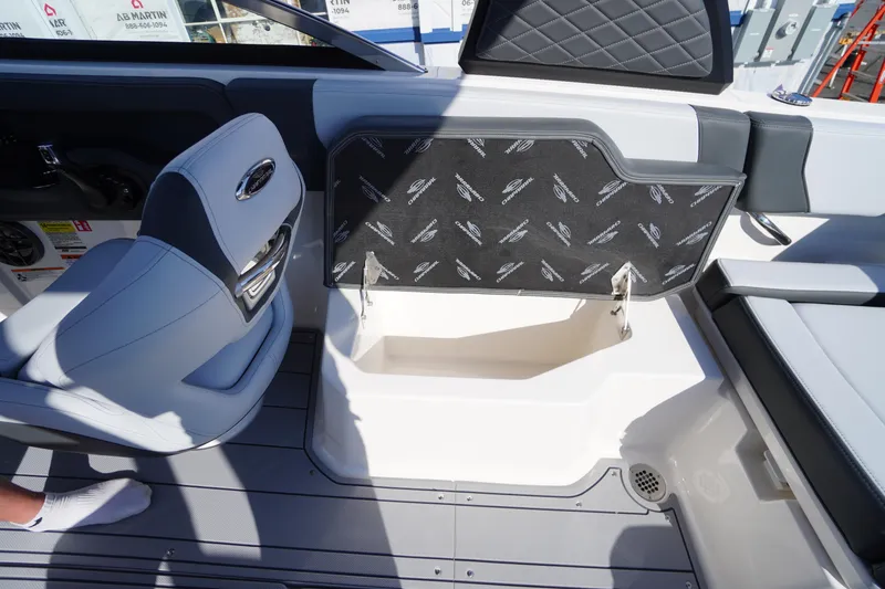 Slide: The Image of Interior view of 2026 Chaparral 250 OSX boat, featuring seating and storage compartment. - 41