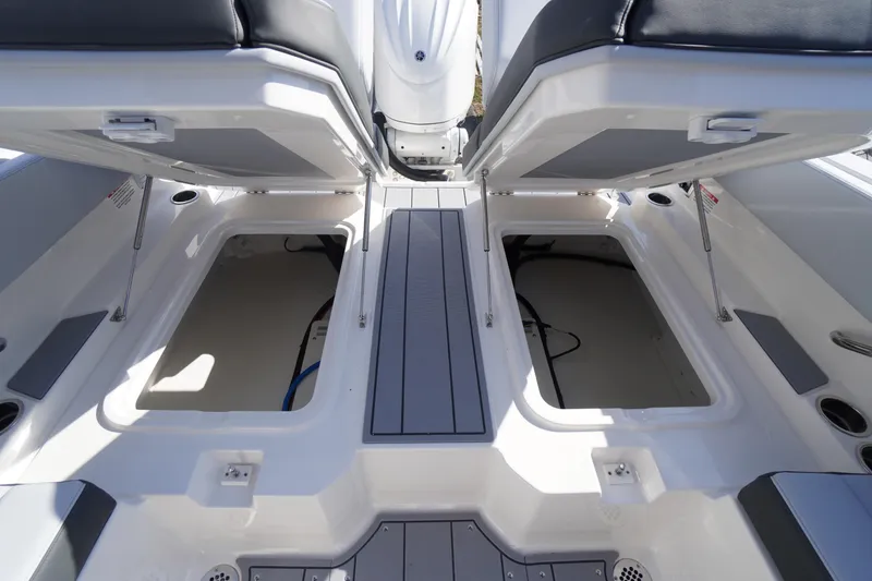 Slide: The Image of 2026 Chaparral 250 OSX boat interior storage compartments with open seats. - 45