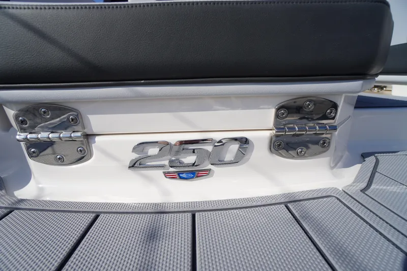 Slide: The Image of 2026 Chaparral 250 OSX boat emblem and hinges on deck. - 53