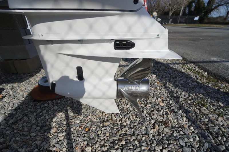 Slide: The Image of 2026 Chaparral 250 OSX boat with Yamaha propeller on gravel surface. - 56