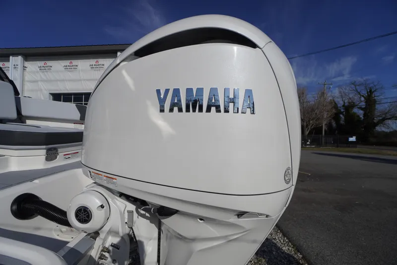 Slide: The Image of 2026 Chaparral 250 OSX with Yamaha outboard motor, parked outdoors. - 57