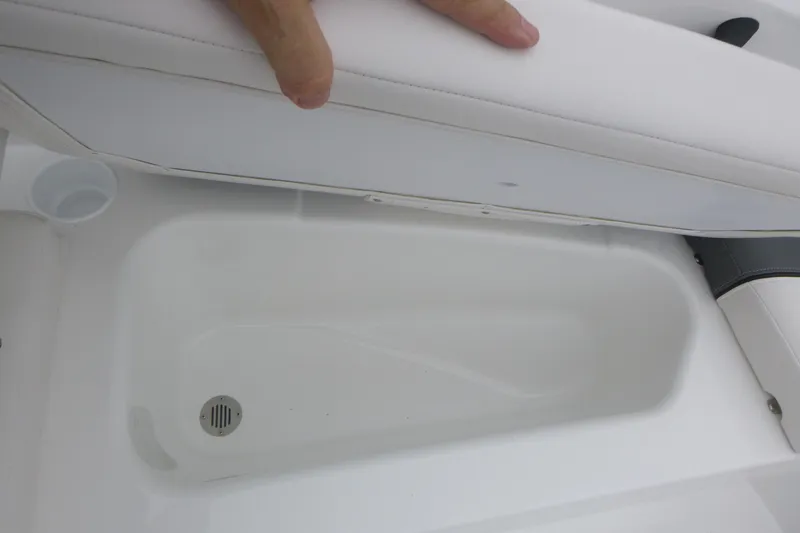 Slide: The Image of 2026 Tahoe T16 boat storage compartment with white cushioned seat. - 12