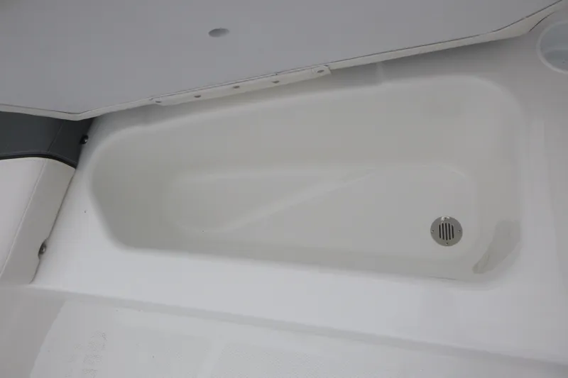 Slide: The Image of 2026 Tahoe T16 boat storage compartment with drain, featuring sleek white interior design. - 13