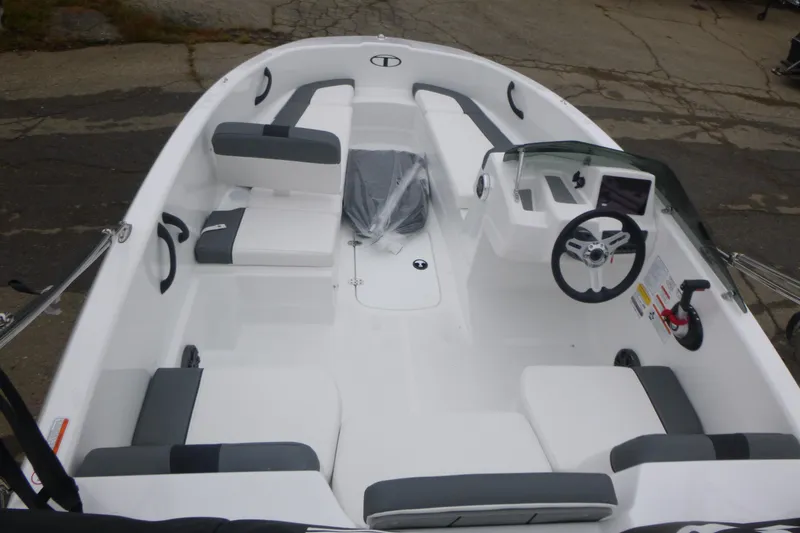 Slide: The Image of 2026 Tahoe T16 boat interior with white and gray seating, steering wheel, and dashboard. - 4
