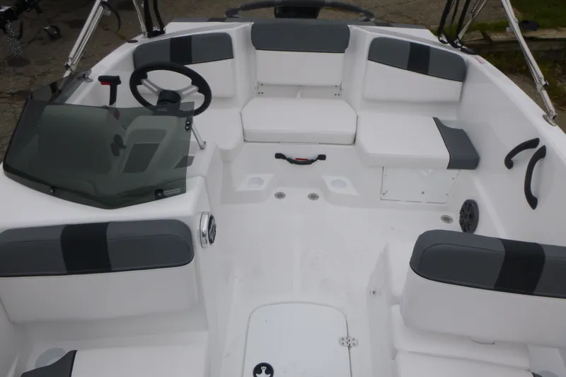 Slide: The Image of 2026 Tahoe T16 boat interior with gray and white seating, steering wheel, and windshield. - 5