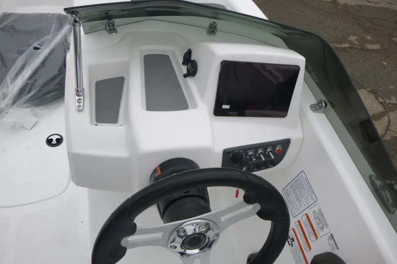 Slide: The Image of 2026 Tahoe T16 boat dashboard with steering wheel and control panel. - 9