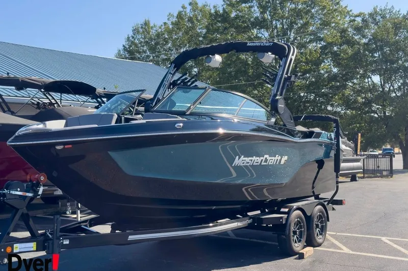 Slide: The Image of 2026 MasterCraft XT22 T boat on trailer, parked outdoors under clear sky. - 3