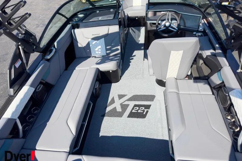 Slide: The Image of 2026 MasterCraft XT22 T boat interior with sleek seating and modern dashboard design. - 7