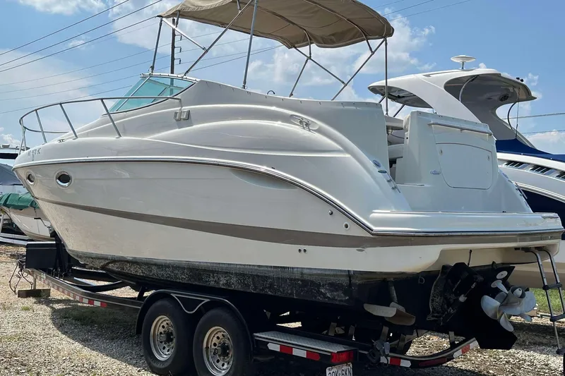 Slide: The Image of 2000 Maxum 2700 SCR boat on trailer, side view, with canopy under blue sky. - 10