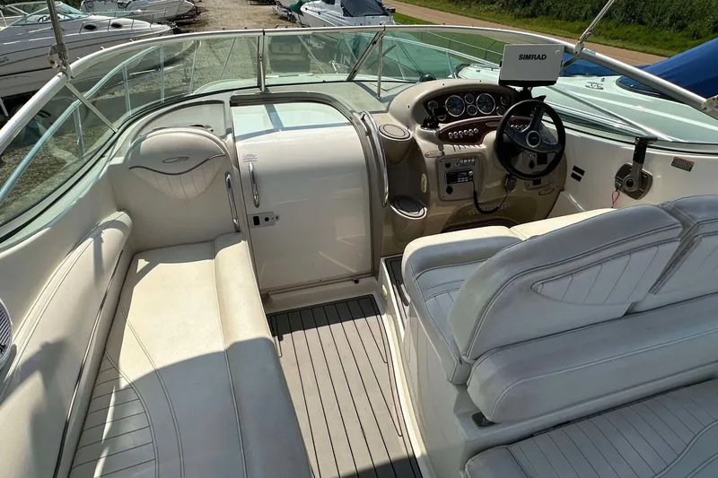 Slide: The Image of Interior view of a 2000 Maxum 2700 SCR boat with white seating and control panel. - 11