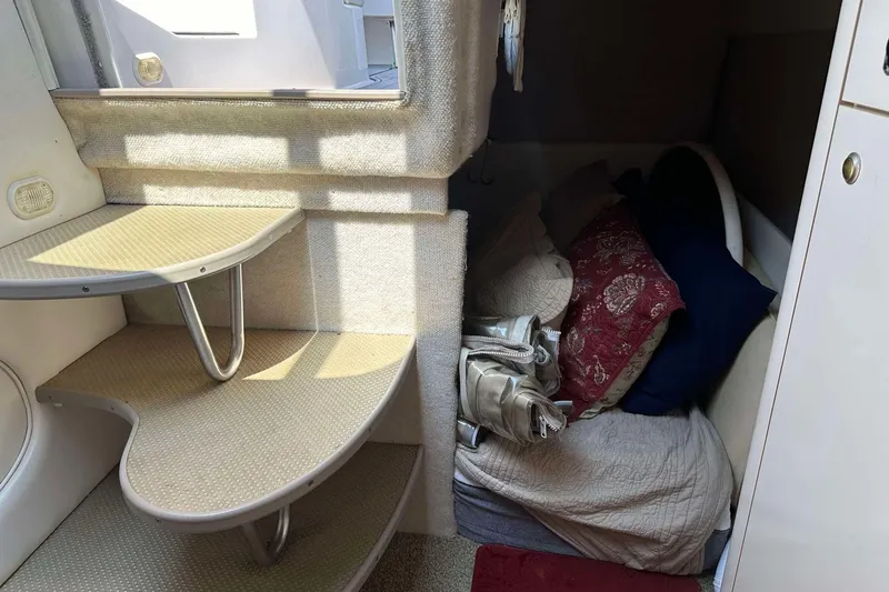 Slide: The Image of Interior of 2000 Maxum 2700 SCR boat with stairs and cozy sleeping area. - 12