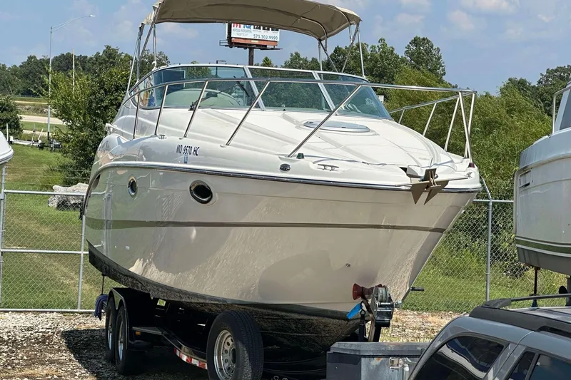 Slide: The Image of 2000 Maxum 2700 SCR boat on trailer, parked outdoors, sunny day. - 15