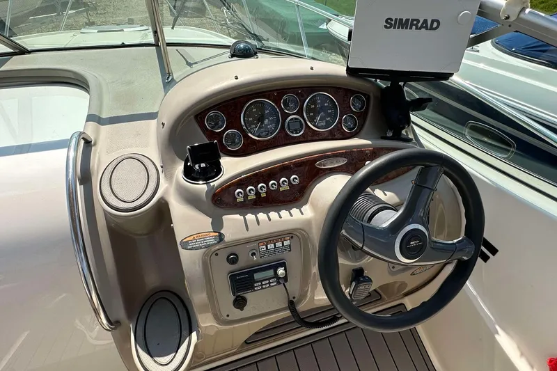 Slide: The Image of Cockpit of 2000 Maxum 2700 SCR boat with steering wheel and control panel. - 16