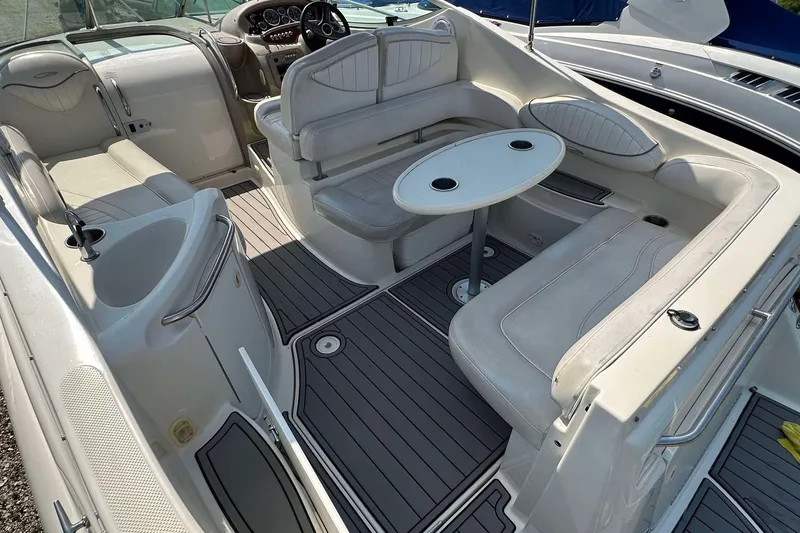 Slide: The Image of 2000 Maxum 2700 SCR boat interior with seating and table, featuring a sleek design. - 17
