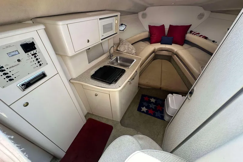 Slide: The Image of Interior of 2000 Maxum 2700 SCR boat with kitchenette and seating area. - 4