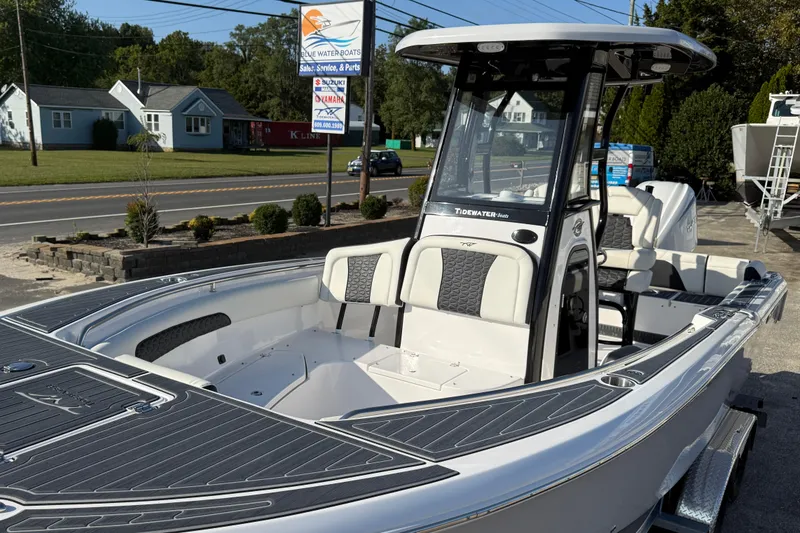 Slide: The Image of 2023 Tidewater 232 SS boat with sleek design, parked outdoors near dealership. - 11