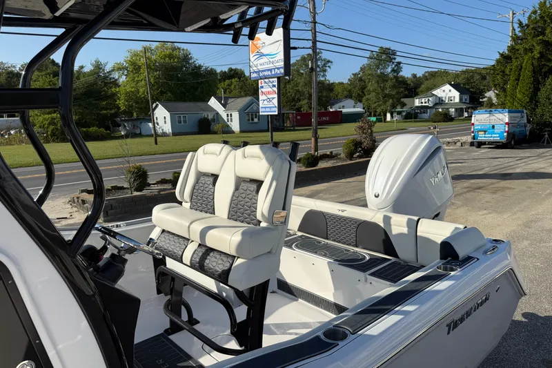 Slide: The Image of 2023 Tidewater 232 SS boat with sleek seating and Yamaha engine, parked outdoors. - 12