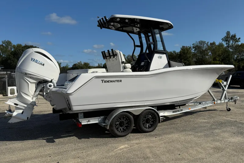 Slide: The Image of 2023 Tidewater 232 SS boat on trailer with Yamaha engine, parked outdoors. - 2
