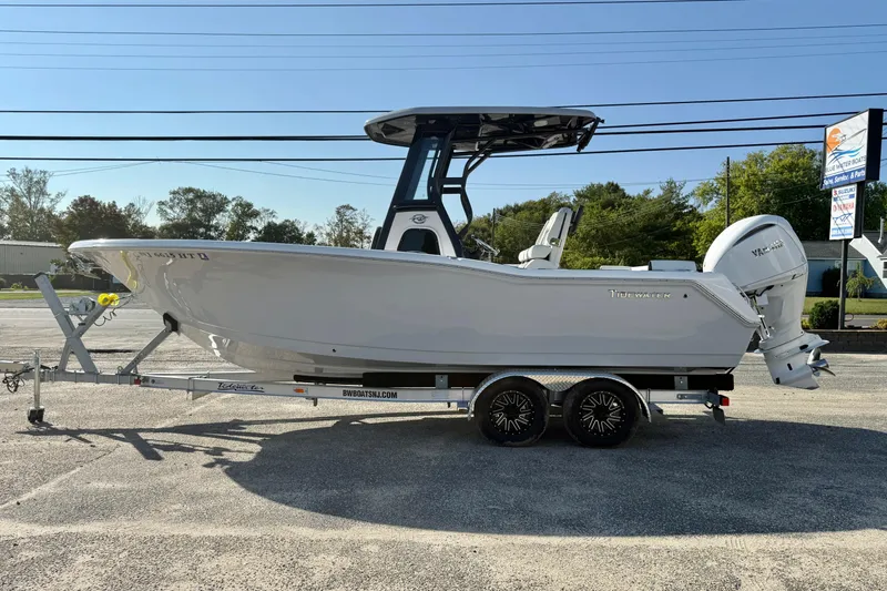 Slide: The Image of 2023 Tidewater 232 SS boat on trailer, side view, outdoors. - 4