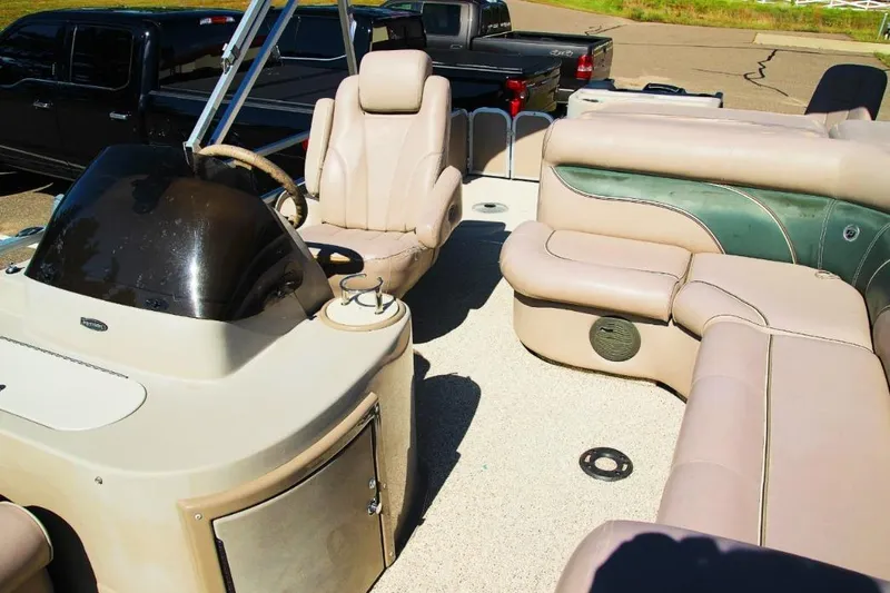 Slide: The Image of 2008 Premier 221 Cast-A-Way boat interior with beige seating and steering console. - 13