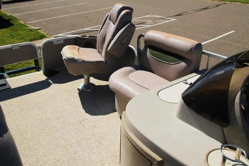 Slide: The Image of 2008 Premier 221 Cast-A-Way boat interior with seating and console in a parking lot. - 6