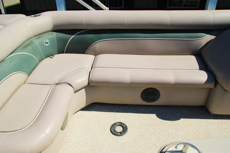 Slide: The Image of 2008 Premier 221 Cast-A-Way boat interior with beige and green seating. - 8