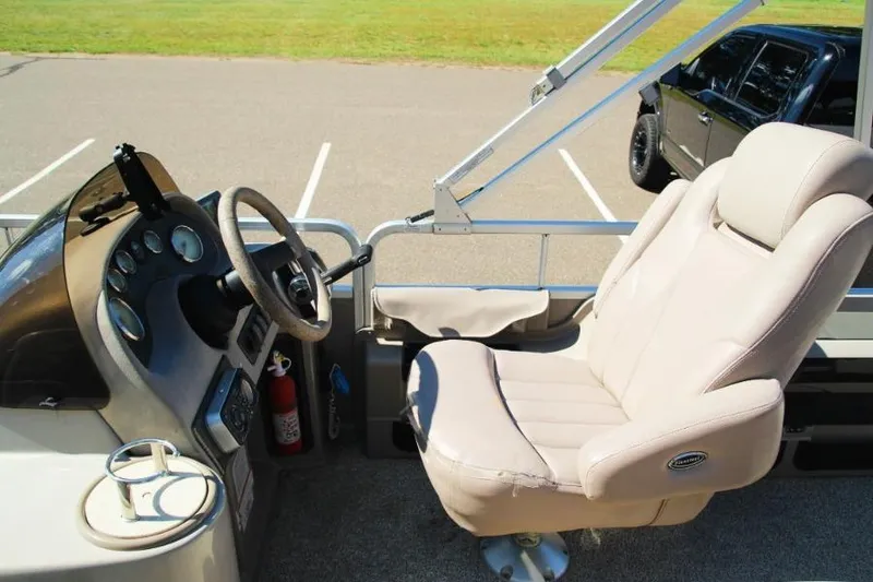 Slide: The Image of Captain's seat and helm of 2008 Premier 221 Cast-A-Way boat in parking lot. - 9