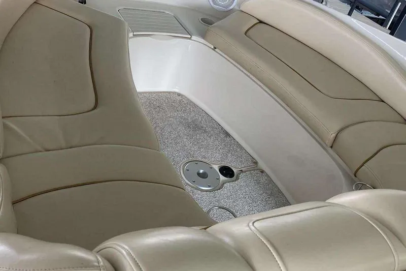 Slide: The Image of Interior seating of 2002 Sea Ray 270 Sundeck boat with beige upholstery. - 13