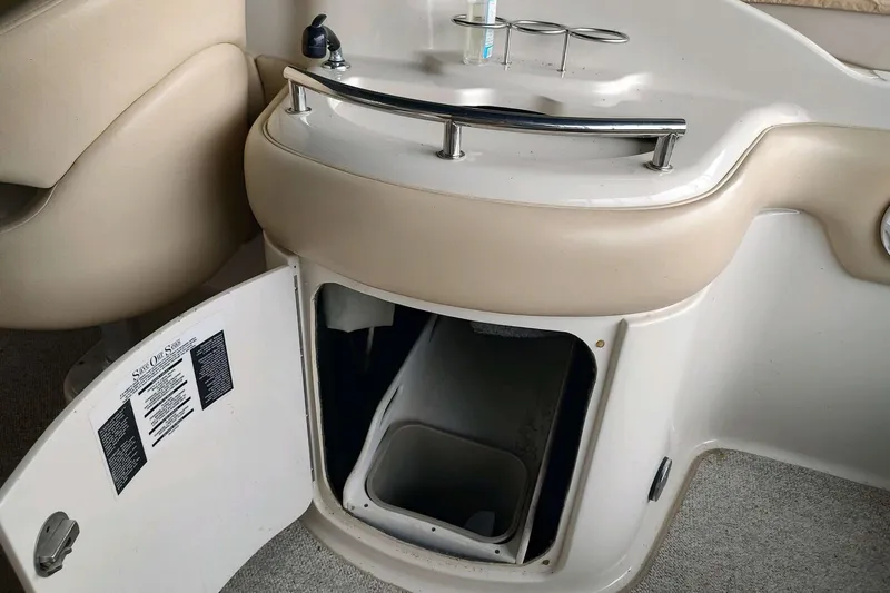 Slide: The Image of Interior of a 2002 Sea Ray 270 Sundeck boat with open storage compartment. - 17